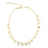 A delicate gold charm necklace sparkles against a plain white background, featuring dangling celestial charms shaped like tiny stars, moons, and hearts.