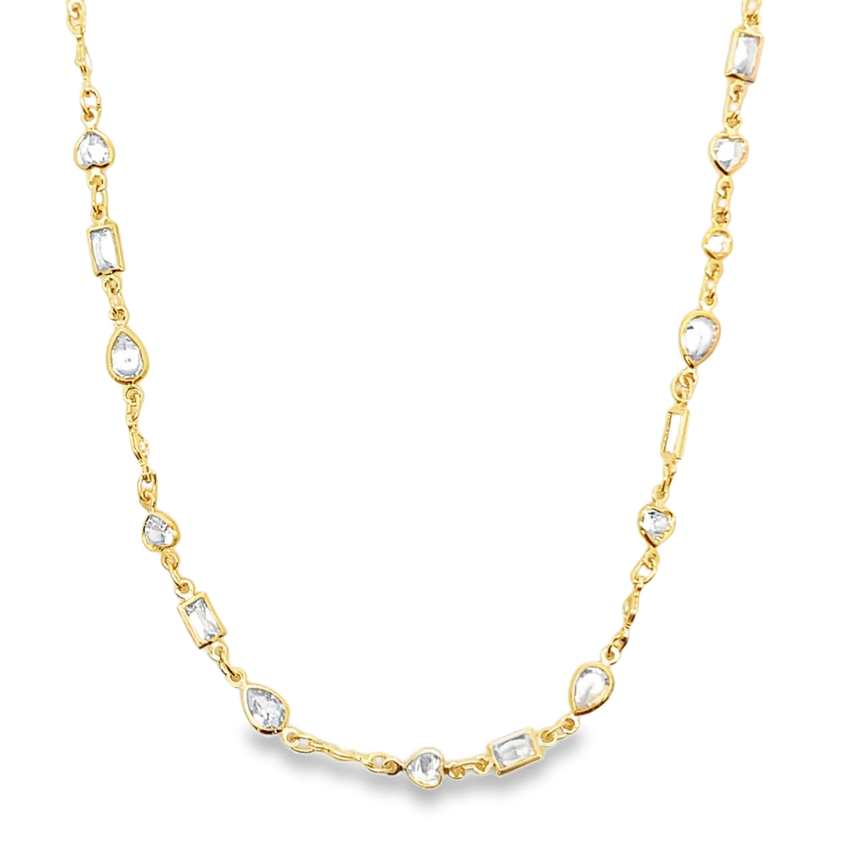 A delicate gold chain necklace sparkles with a variety of mixed-cut crystal and diamond stations against a white background.