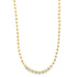 A delicate gold ball chain necklace hangs against a white background.