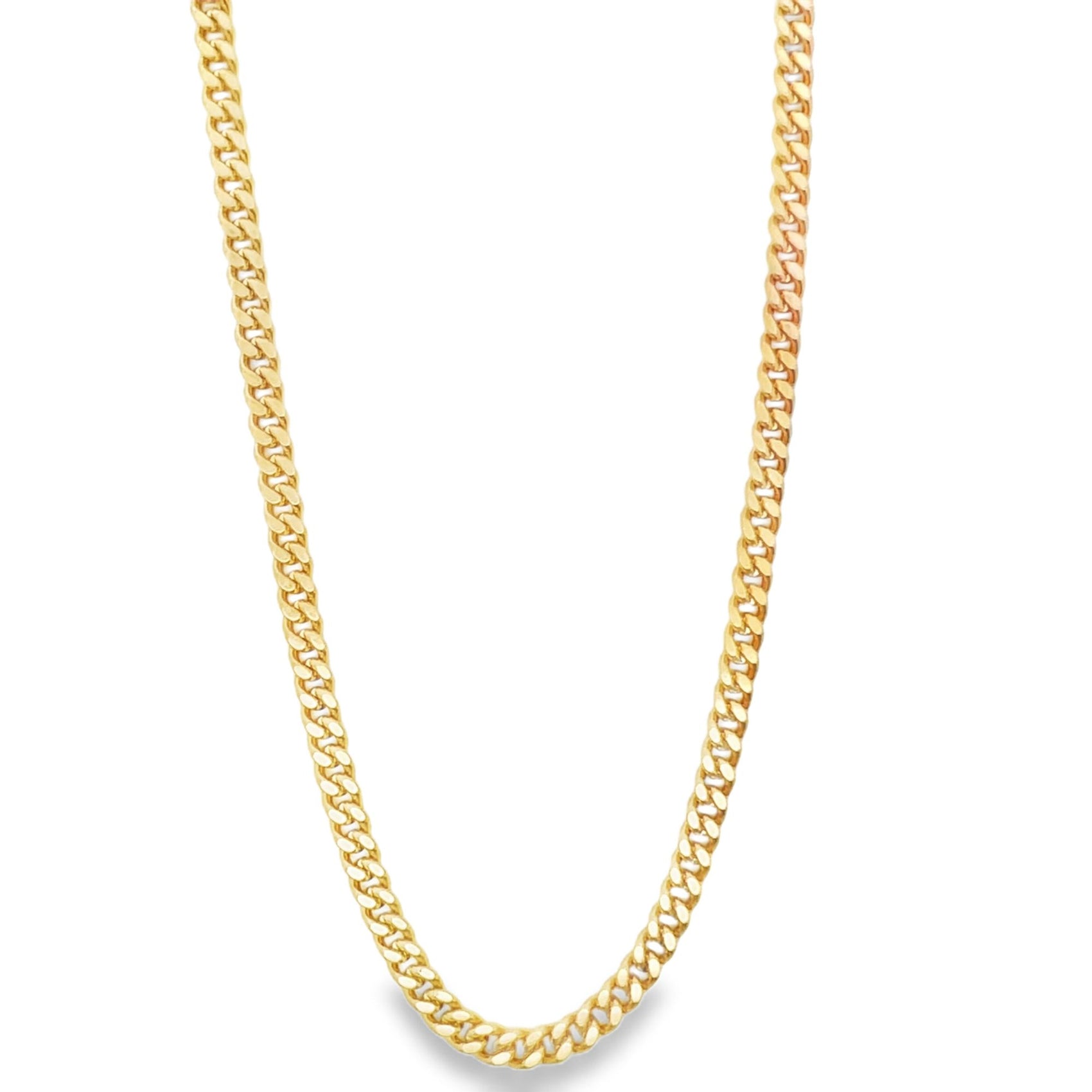 A polished gold cuban link chain necklace drapes against a clean white background.