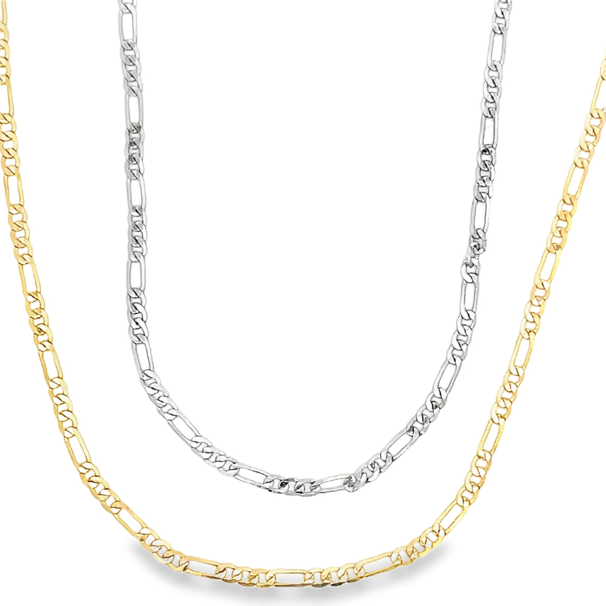 A silver Figaro chain necklace and a gold Figaro chain necklace overlap against a plain white background.