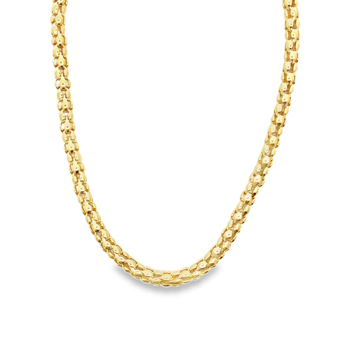 A thick, textured gold chain necklace rests against a plain white background.