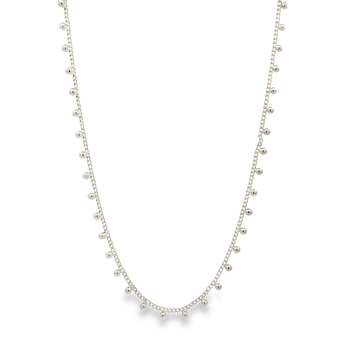 A delicate silver chain necklace features dangling bead charms.
