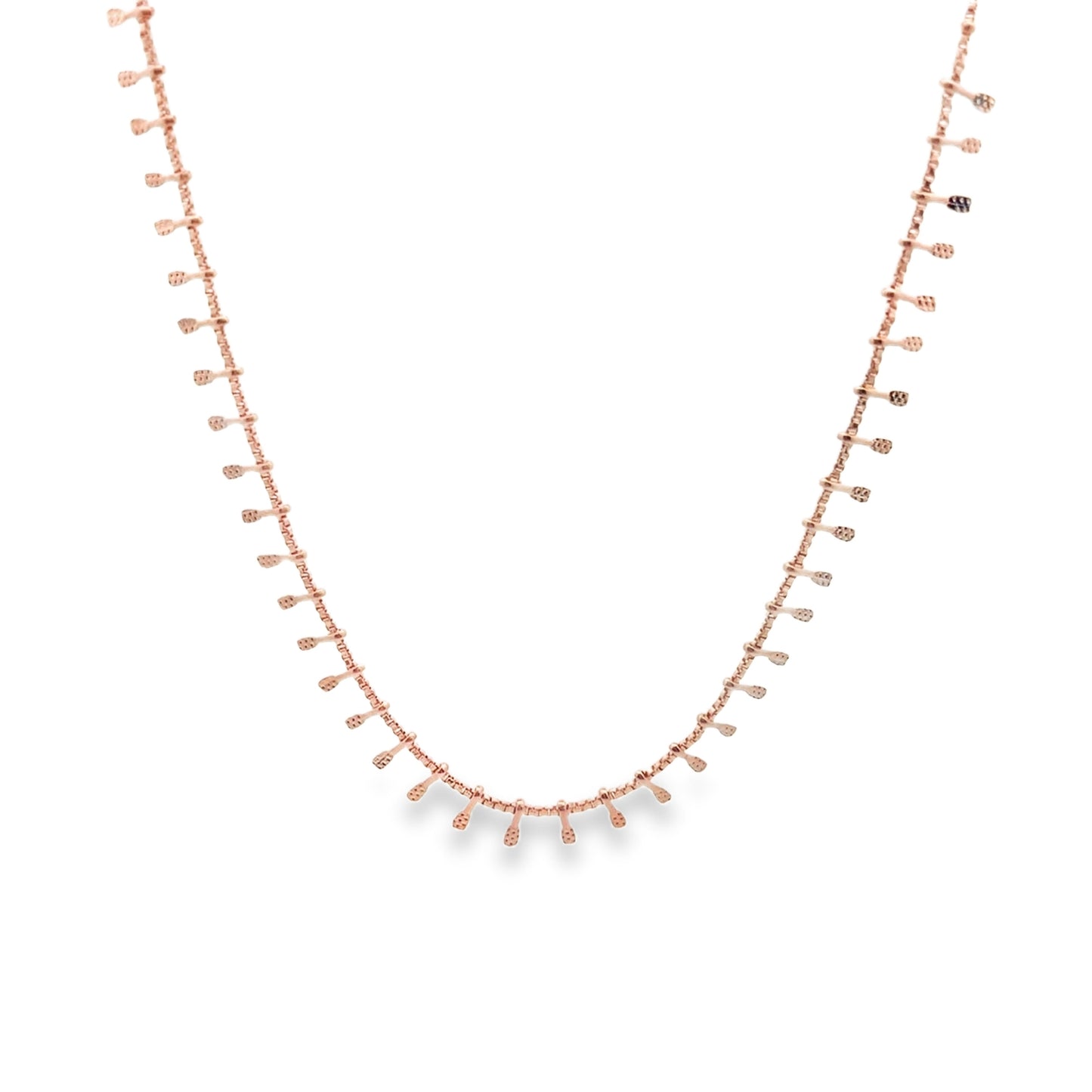 A delicate rose gold chain necklace features small, hanging paddle-like charms evenly spaced along its length against a white background.