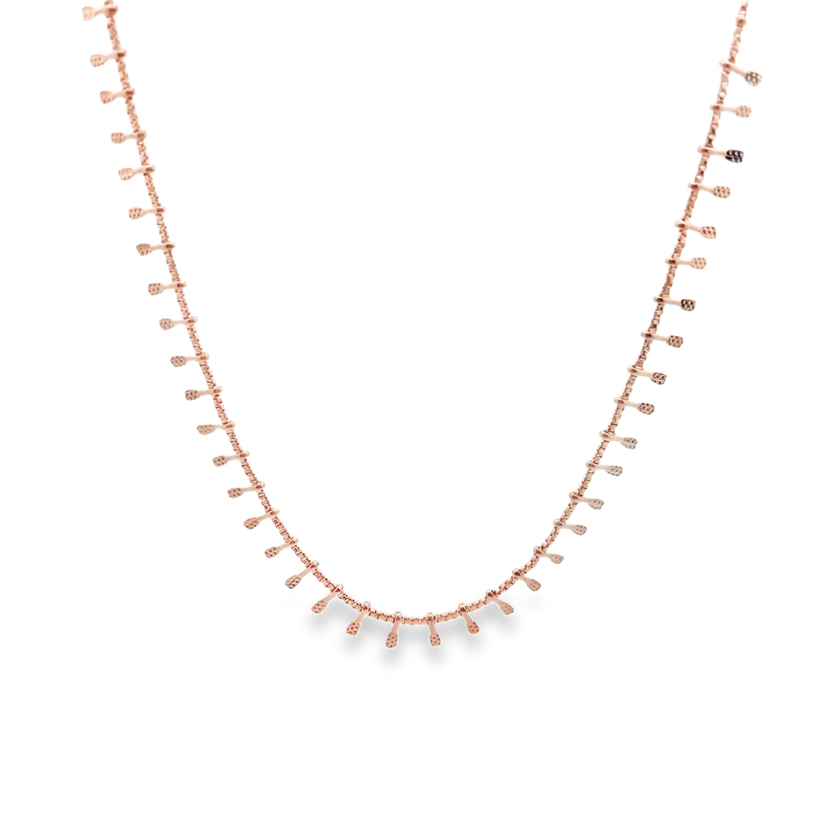 A delicate rose gold chain necklace features small, hanging paddle-like charms evenly spaced along its length against a white background.