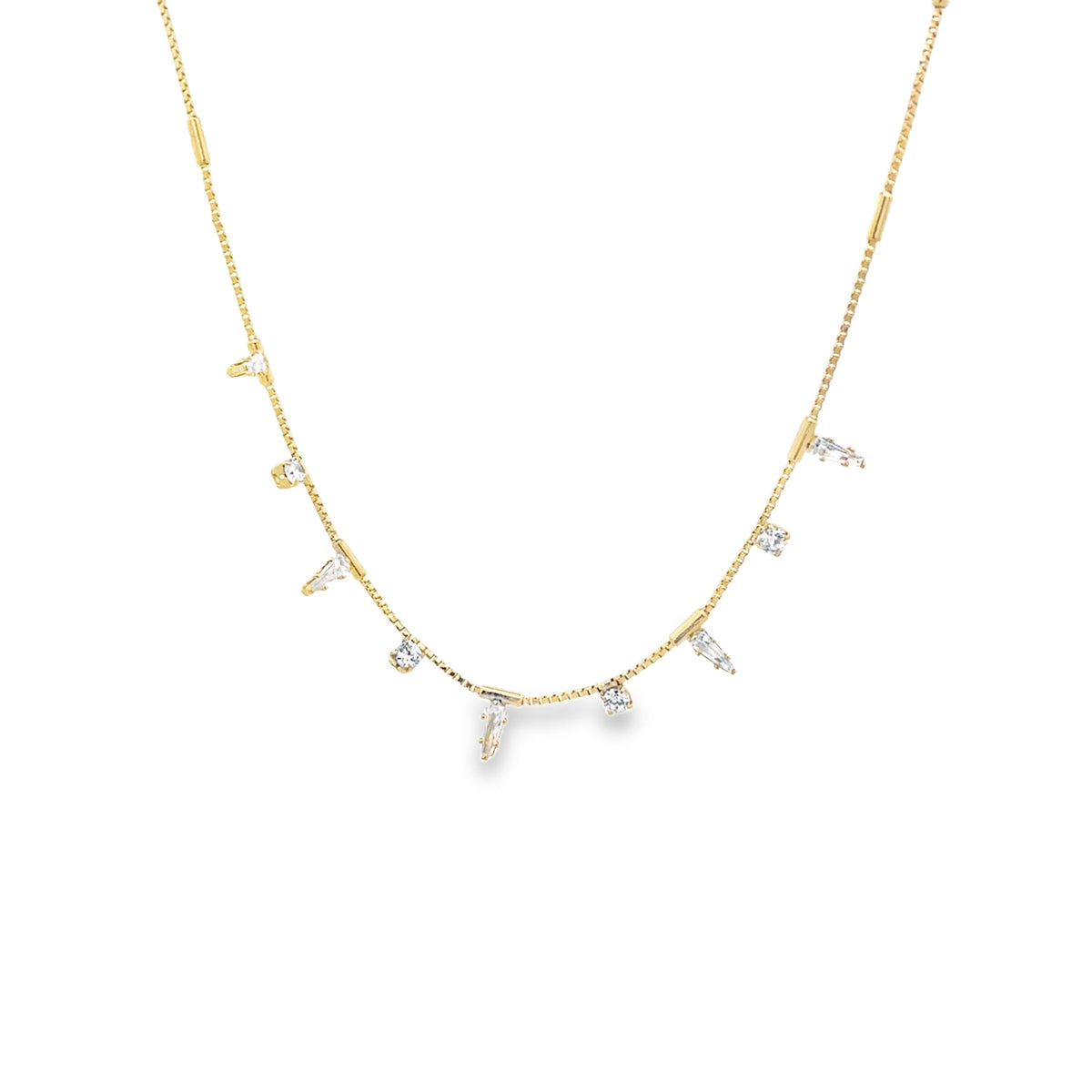 A delicate gold chain necklace drapes elegantly, featuring sparkling diamond charms dangling along its length against a clean white background.