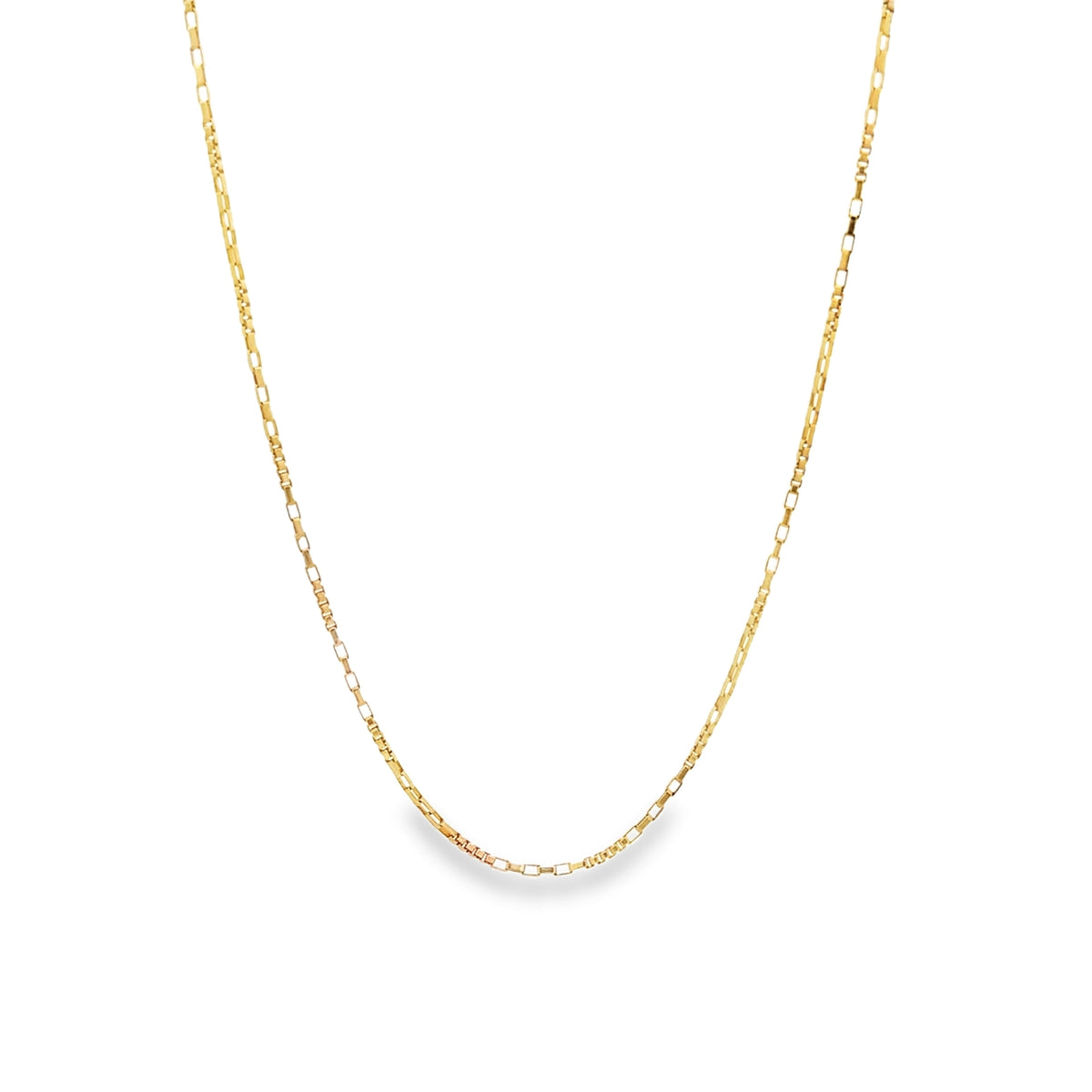 A delicate gold chain necklace hangs against a plain white background.