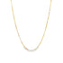 A delicate gold chain necklace hangs against a plain white background.