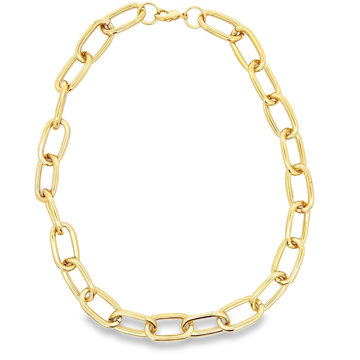 A thick gold paperclip chain necklace rests in an oval shape against a white background.