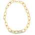 A thick gold paperclip chain necklace rests in an oval shape against a white background.