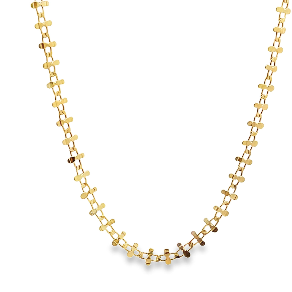 A delicate gold chain necklace with intricate link details hangs in a graceful curve against a clean white background.