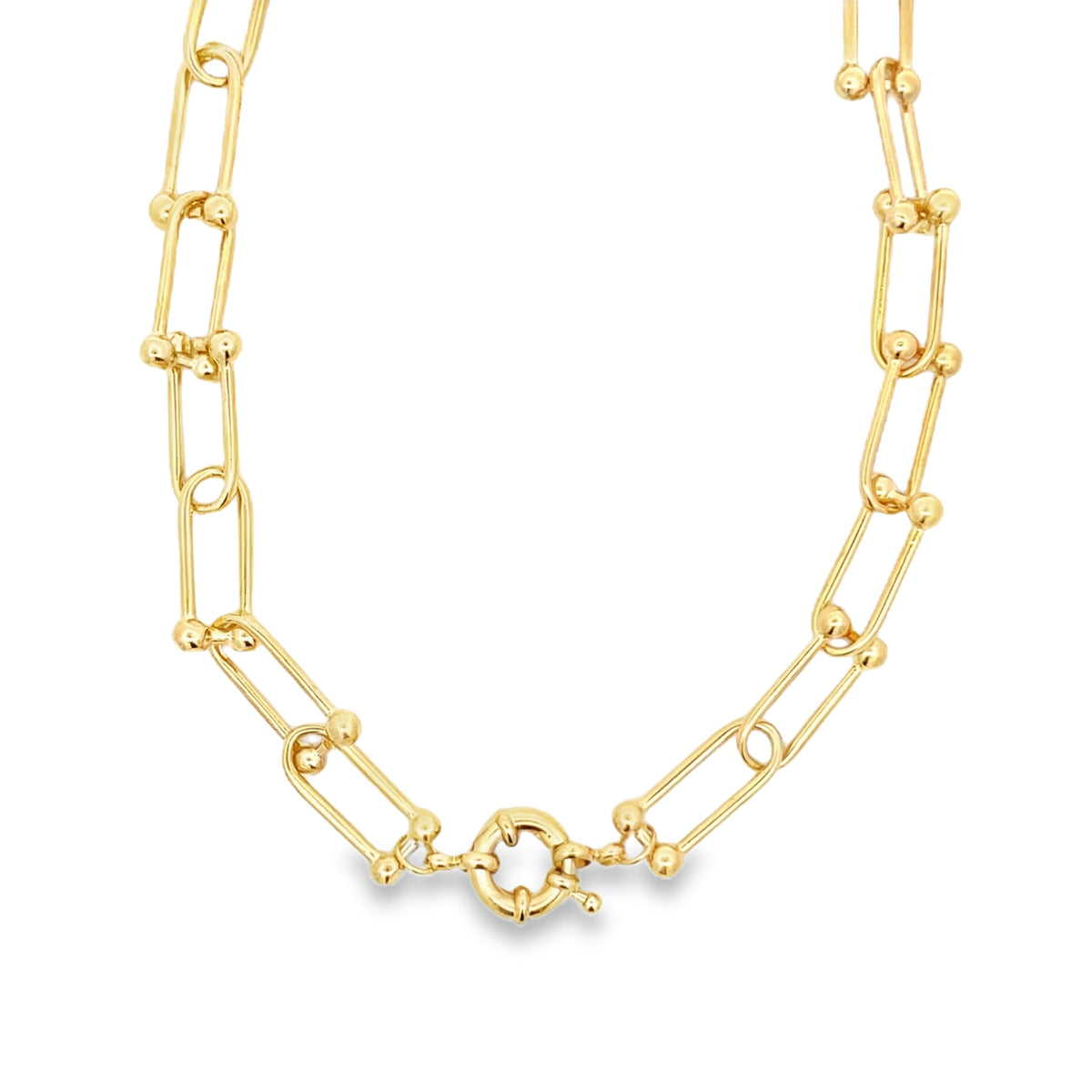 A glossy gold paperclip link necklace features delicate ball accents and a secure round clasp centered against a plain white background.
