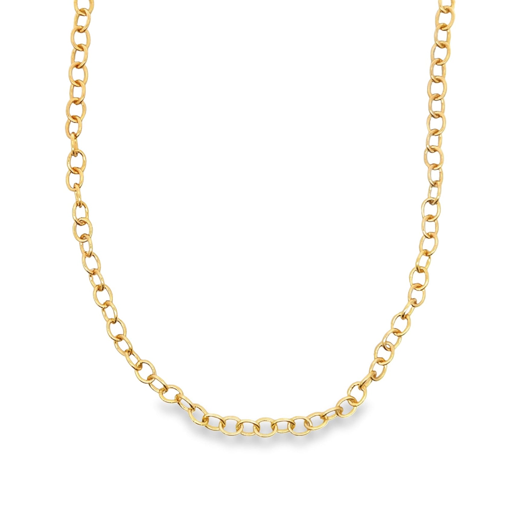 A shiny gold chain necklace forms a gentle curve against a plain white background.