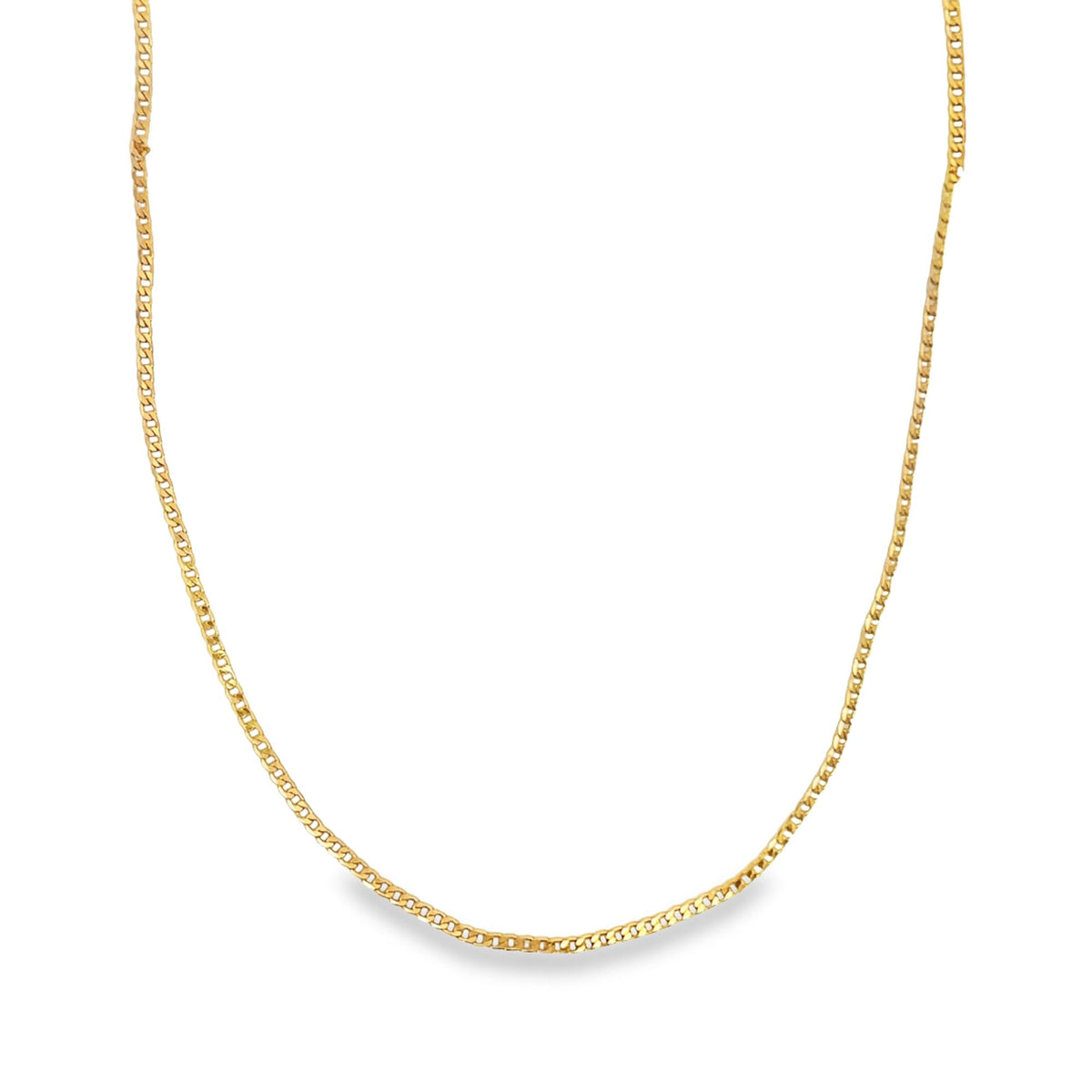 A delicate gold curb chain necklace glimmers against a clean white background.