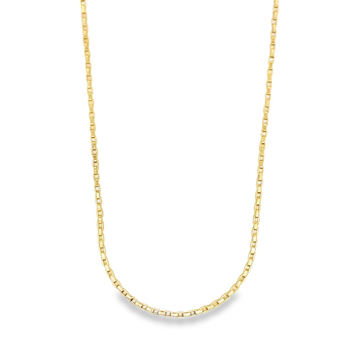 A delicate yellow gold box chain necklace rests against a clean white background.