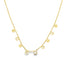 A delicate gold chain necklace dangles charmingly with alternating round discs and sparkling diamond charms.