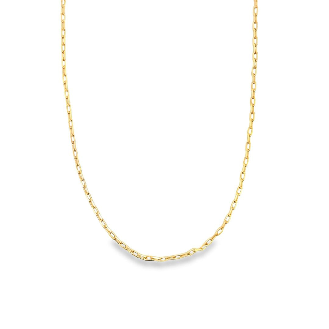 A sleek gold paperclip chain necklace drapes against a clean white background.