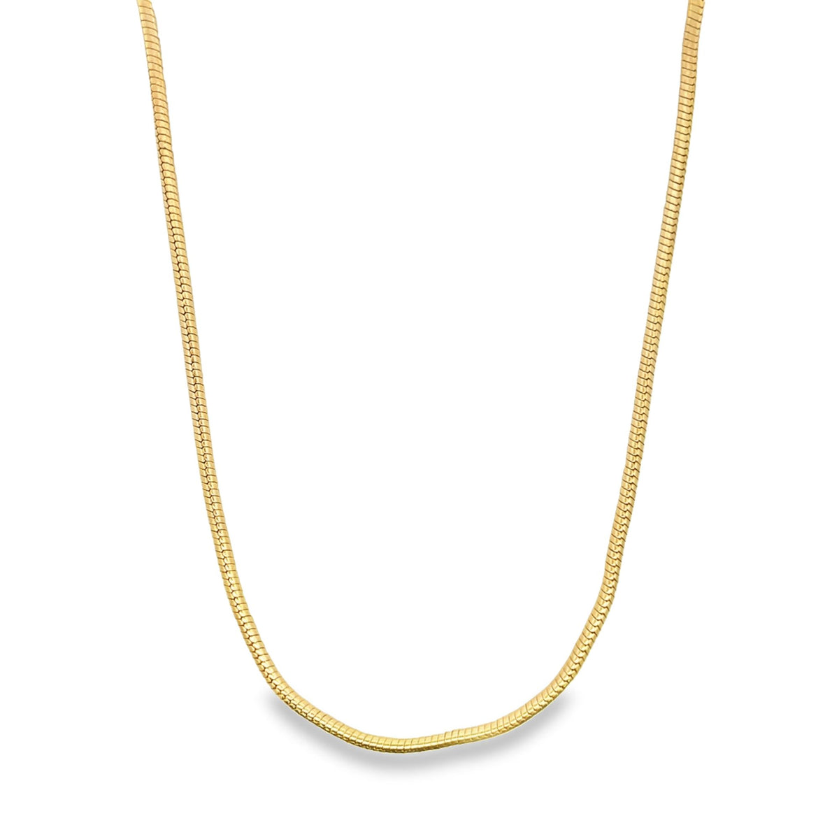A sleek gold snake chain necklace drapes gracefully against a clean white background.