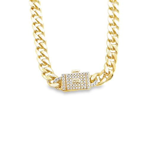 A thick gold Cuban link chain features a sparkling diamond-paved box clasp with an infinity symbol at the center.