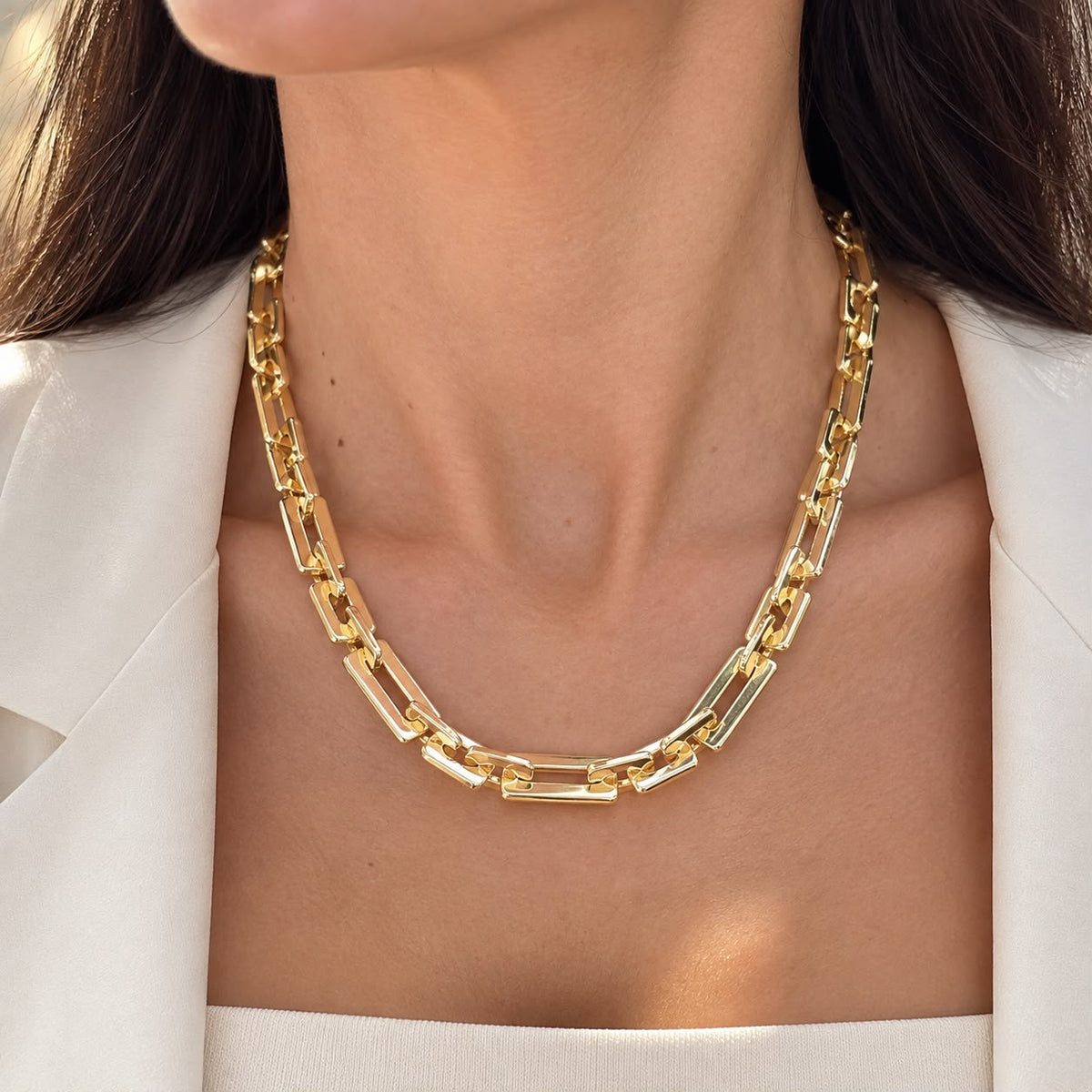 Discover a modern rectangular link necklace with a polished finish and bold statement design. Available in 18K Gold Filled and Rhodium Filled finishes.