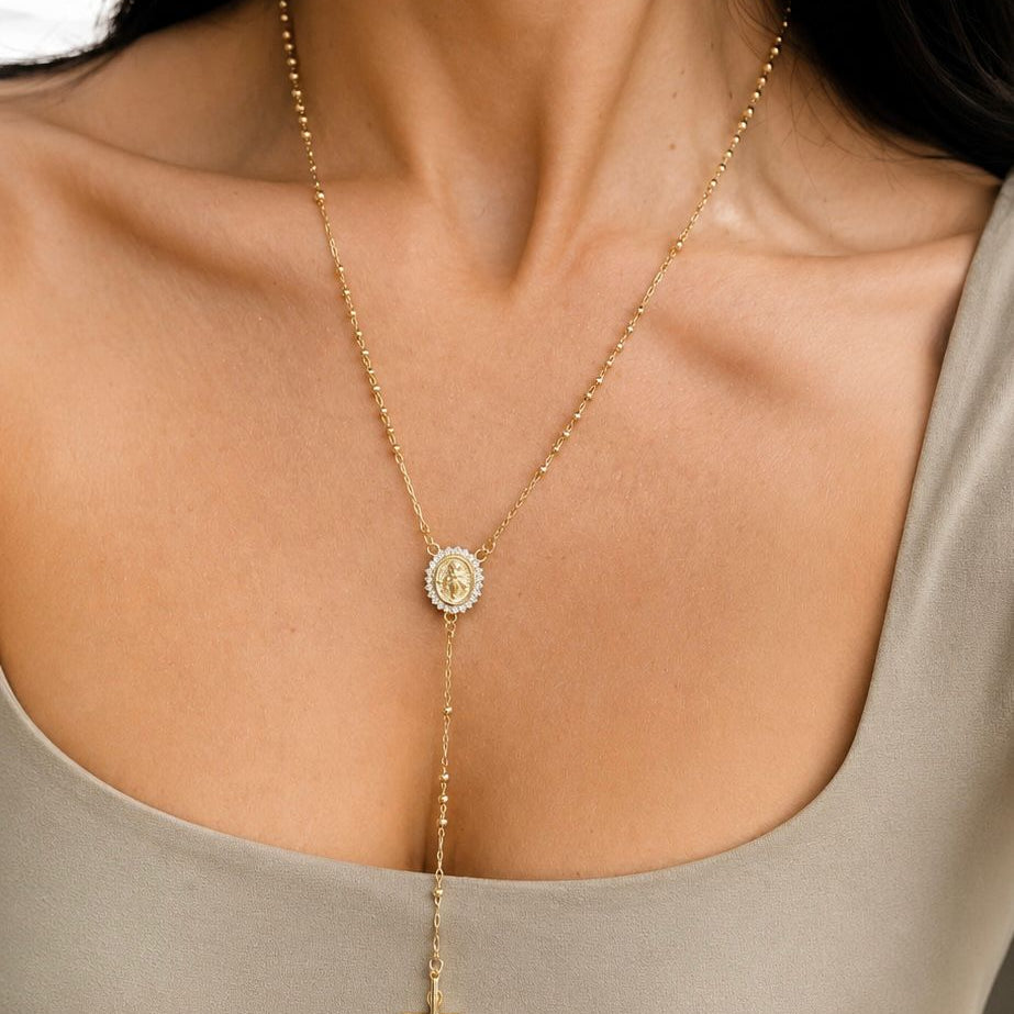 Elegant 18K gold filled rosary necklace featuring a Virgin Mary medal and cross pendant. Available in multiple sizes and thickness options for timeless everyday wear.