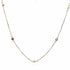 A delicate gold chain necklace features scattered colorful enamel stations against a clean white background.