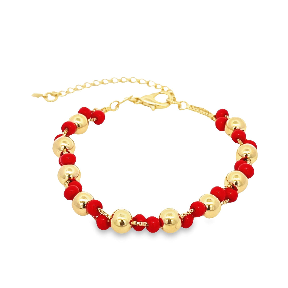 A gold chain bracelet features alternating shiny gold spheres and small red beads, complete with an adjustable extender clasp.