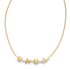 A delicate gold tennis necklace features sparkling pavé diamonds and spells out "MAMA" in gold block letters.