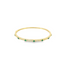 A sleek gold bangle bracelet sparkles with pavé diamonds and features evenly spaced round emerald stones.
