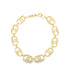 A gold link chain necklace featuring textured oval links lies in a circular shape against a white background.