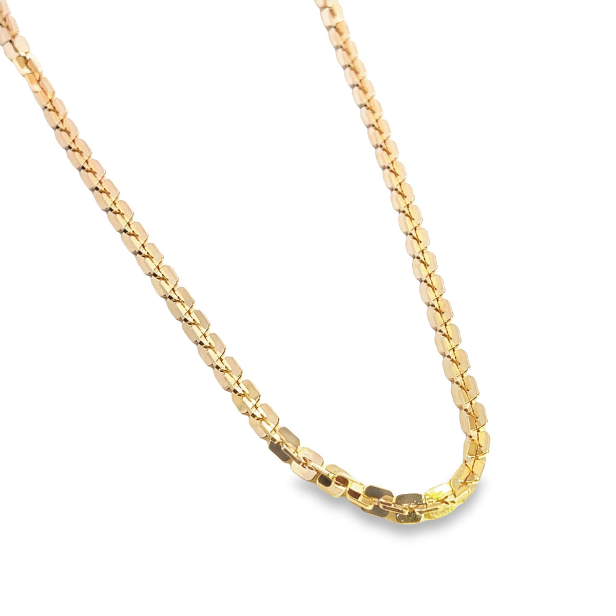 A close-up shot displays a delicate, shimmering gold chain necklace with interlocking links against a clean white background.