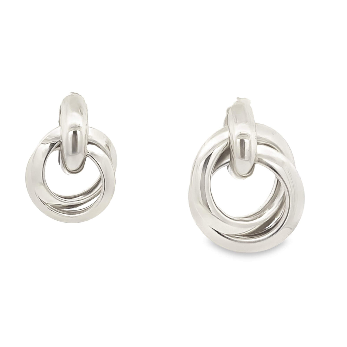 A pair of polished silver interlocking hoop earrings is displayed against a clean white background.