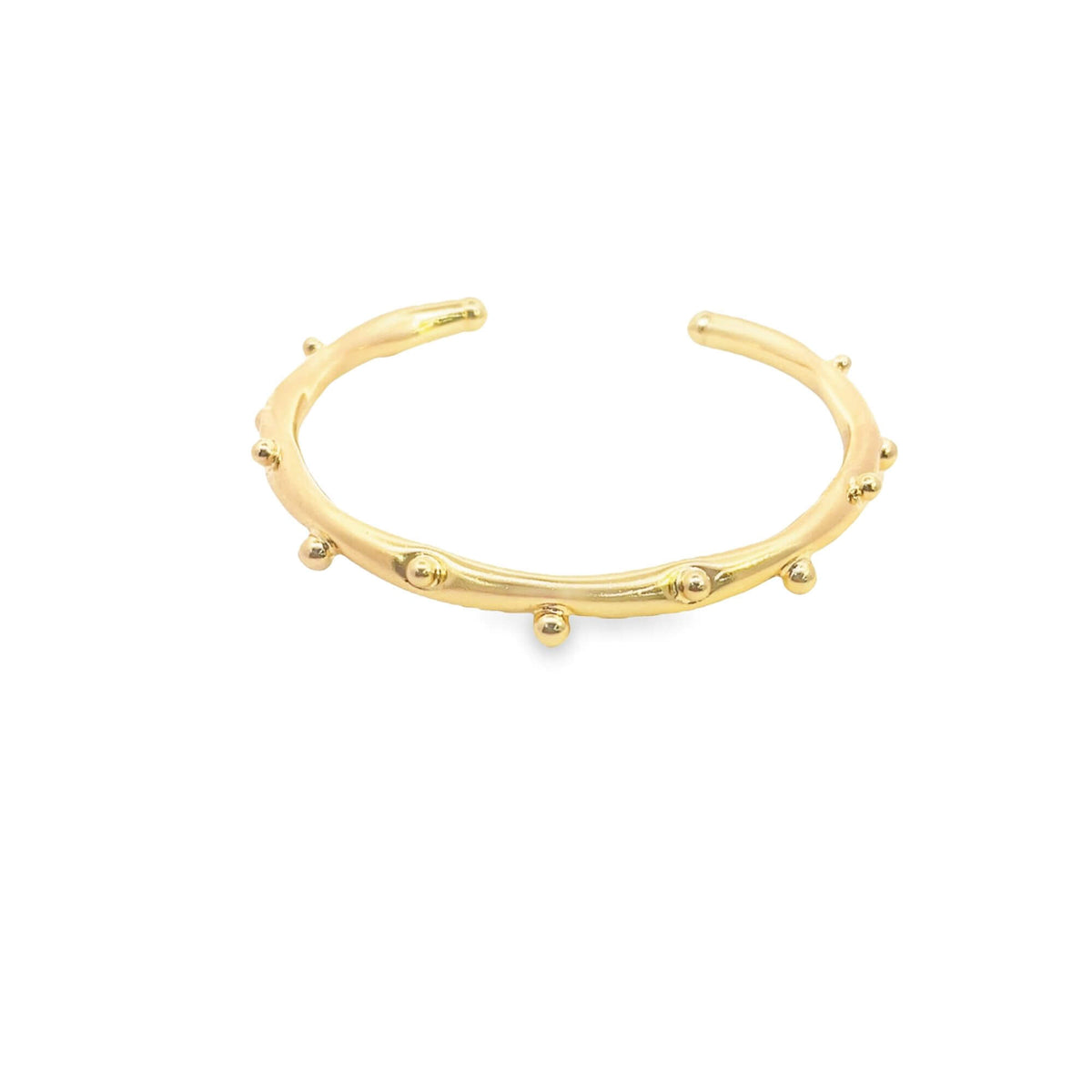 A minimalist gold cuff bracelet features delicate beaded details along its polished band.