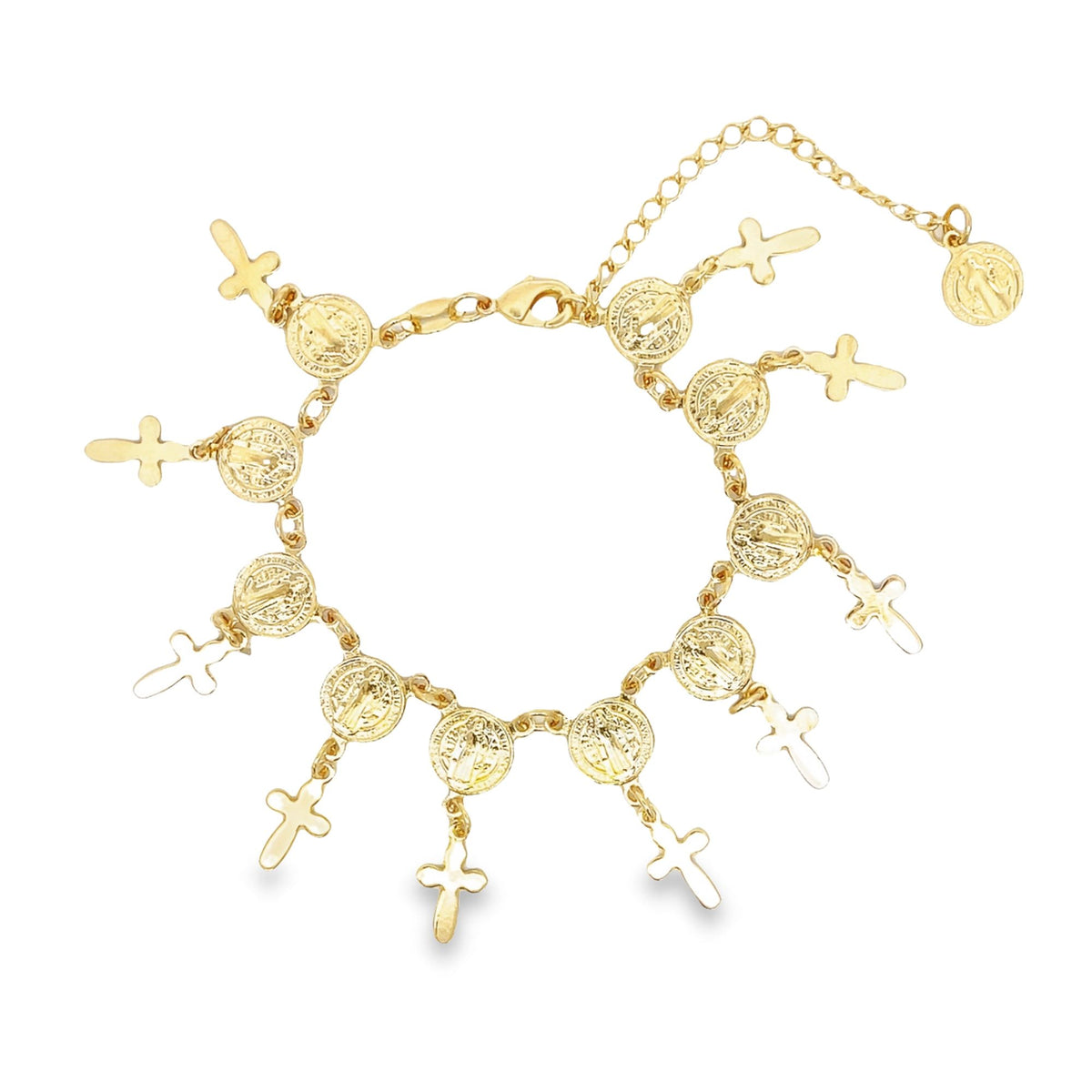 A gold charm bracelet features hanging Saint Benedict medals and cross charms arranged along a delicate chain.
