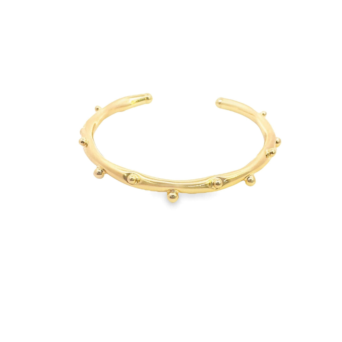 A shiny gold cuff bracelet features delicate, evenly spaced beaded details along its polished band against a clean white background.