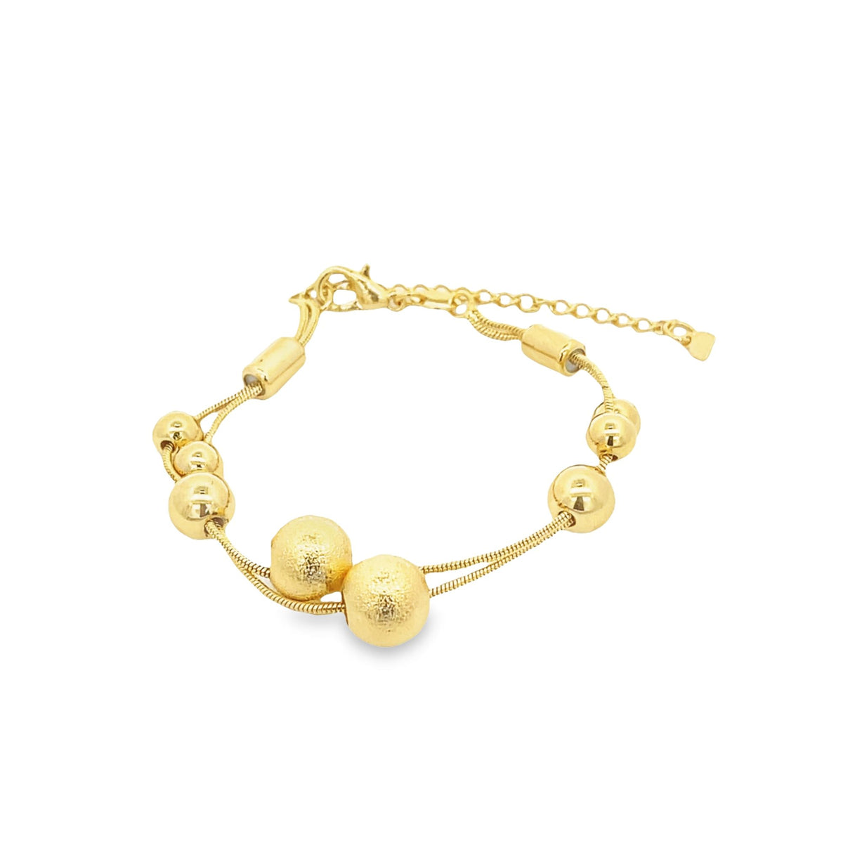 A double-strand gold bracelet features textured beads and smooth spherical charms against a plain white background.