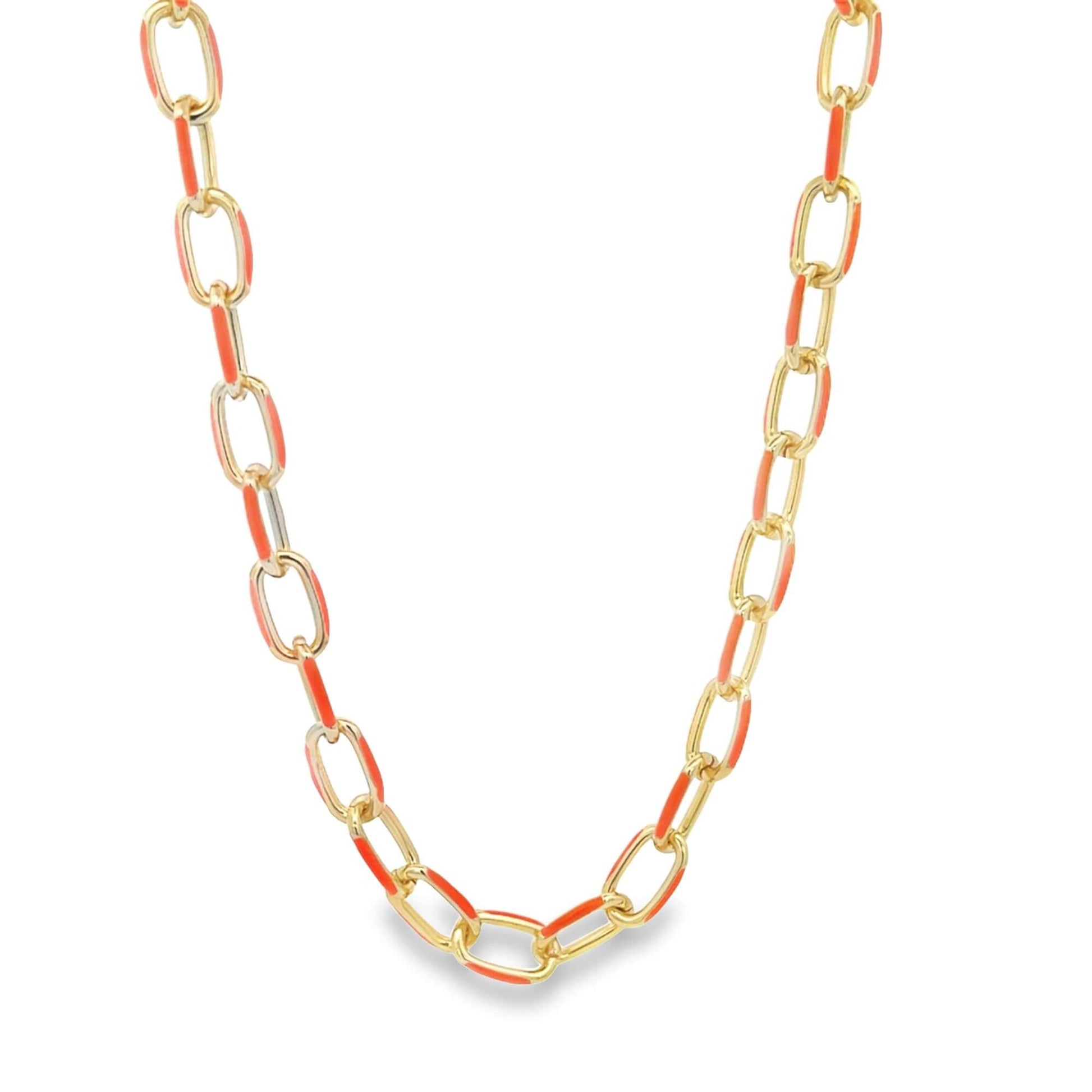 A gold link chain necklace features vibrant orange enamel details on alternate links.