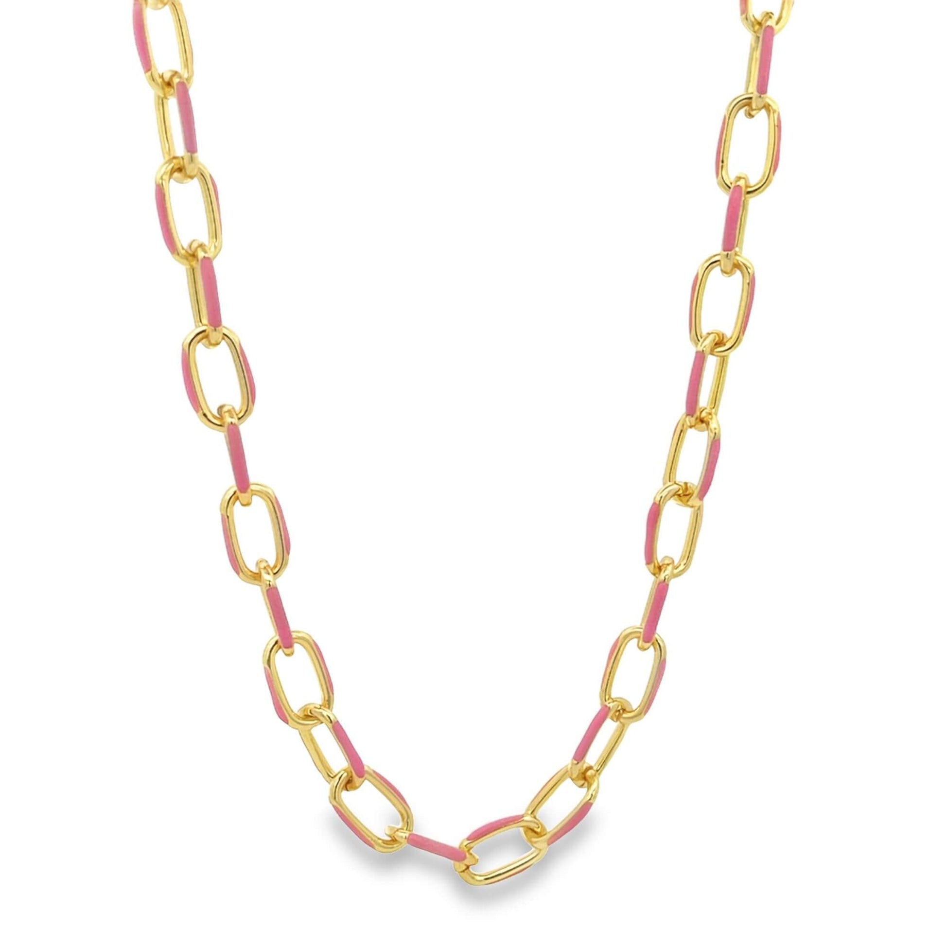 A gold chain necklace features alternating chunky links accented with vibrant pink enamel against a clean white background.