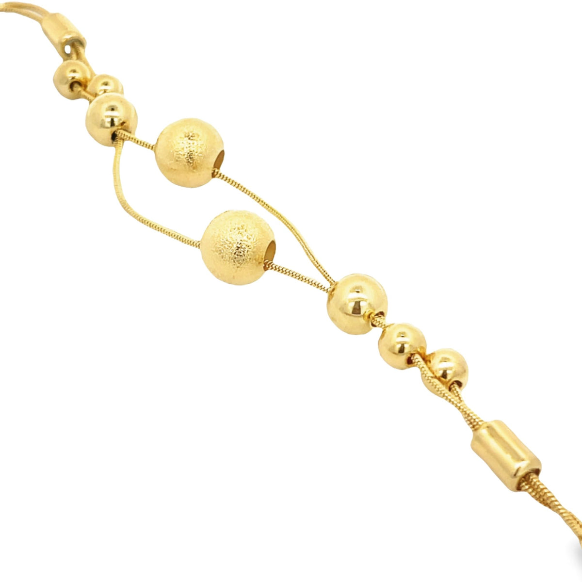 A delicate gold necklace features a series of polished and textured spherical beads threaded along fine chains against a white background.