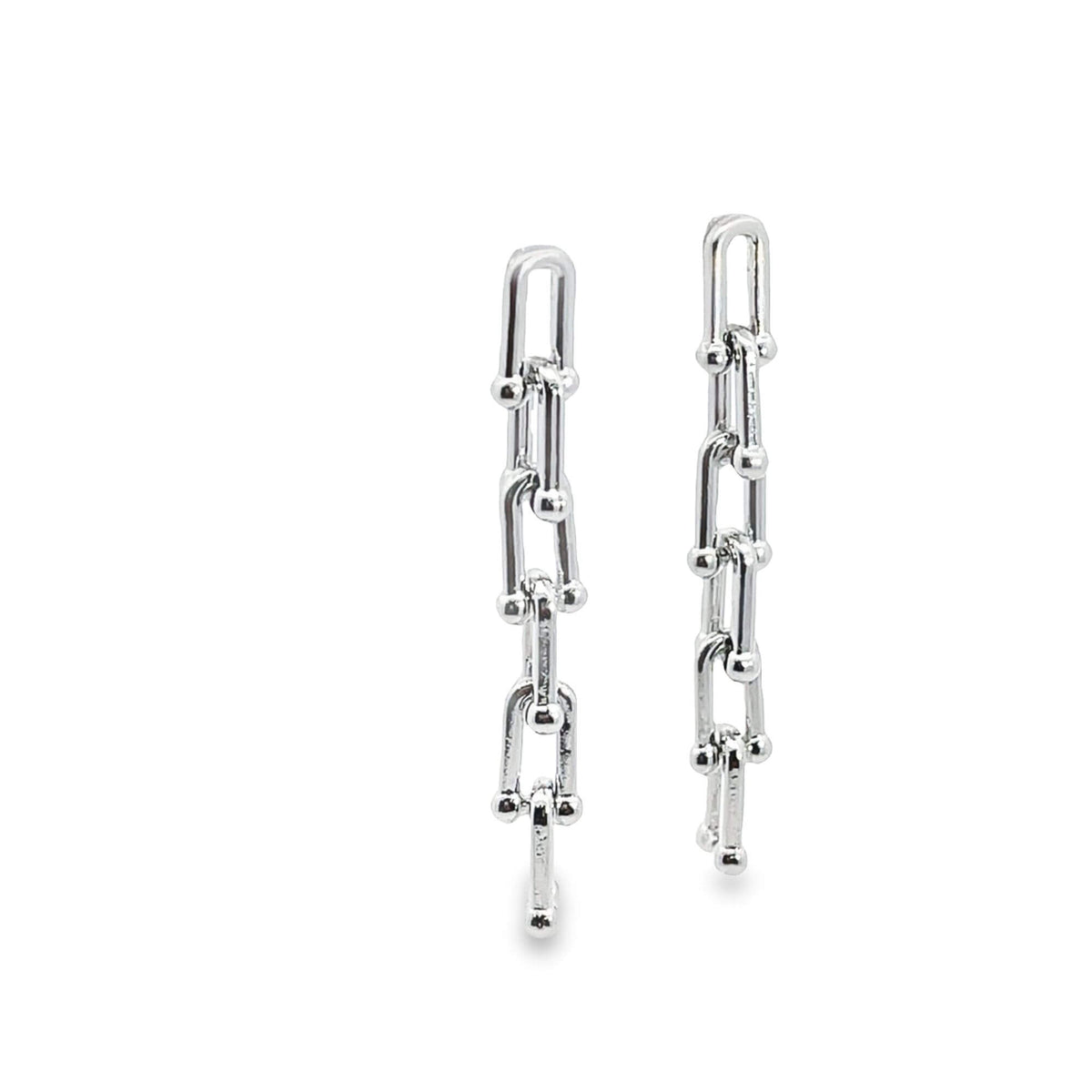 A pair of sleek silver chain-link drop earrings gleams against a white background.