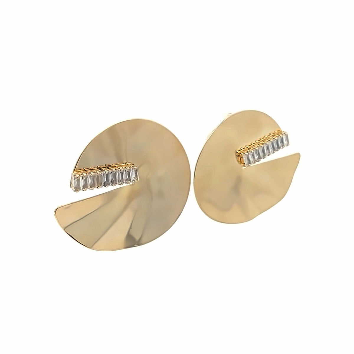 A pair of modern gold disc earrings features inlaid crystal baguette stones across a cutout design.