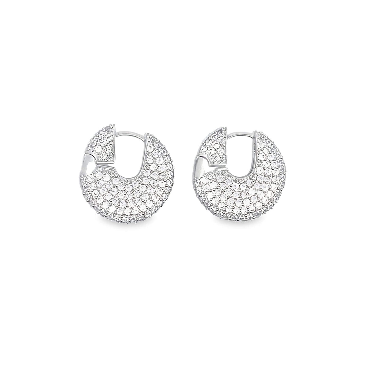 A pair of silver hoop earrings paved with sparkling white diamonds rests against a plain white background.