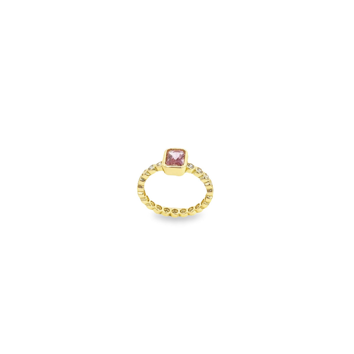 A gold ring features a central pink gemstone and delicate diamond accents along the band against a clean white background.