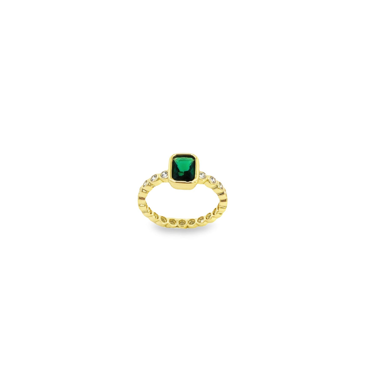 A gold ring features a rectangular green emerald flanked by sparkling diamonds on a textured band.