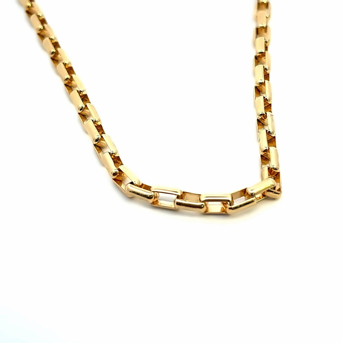 A polished gold link necklace rests against a clean white background, showcasing its intricate geometric chain design.