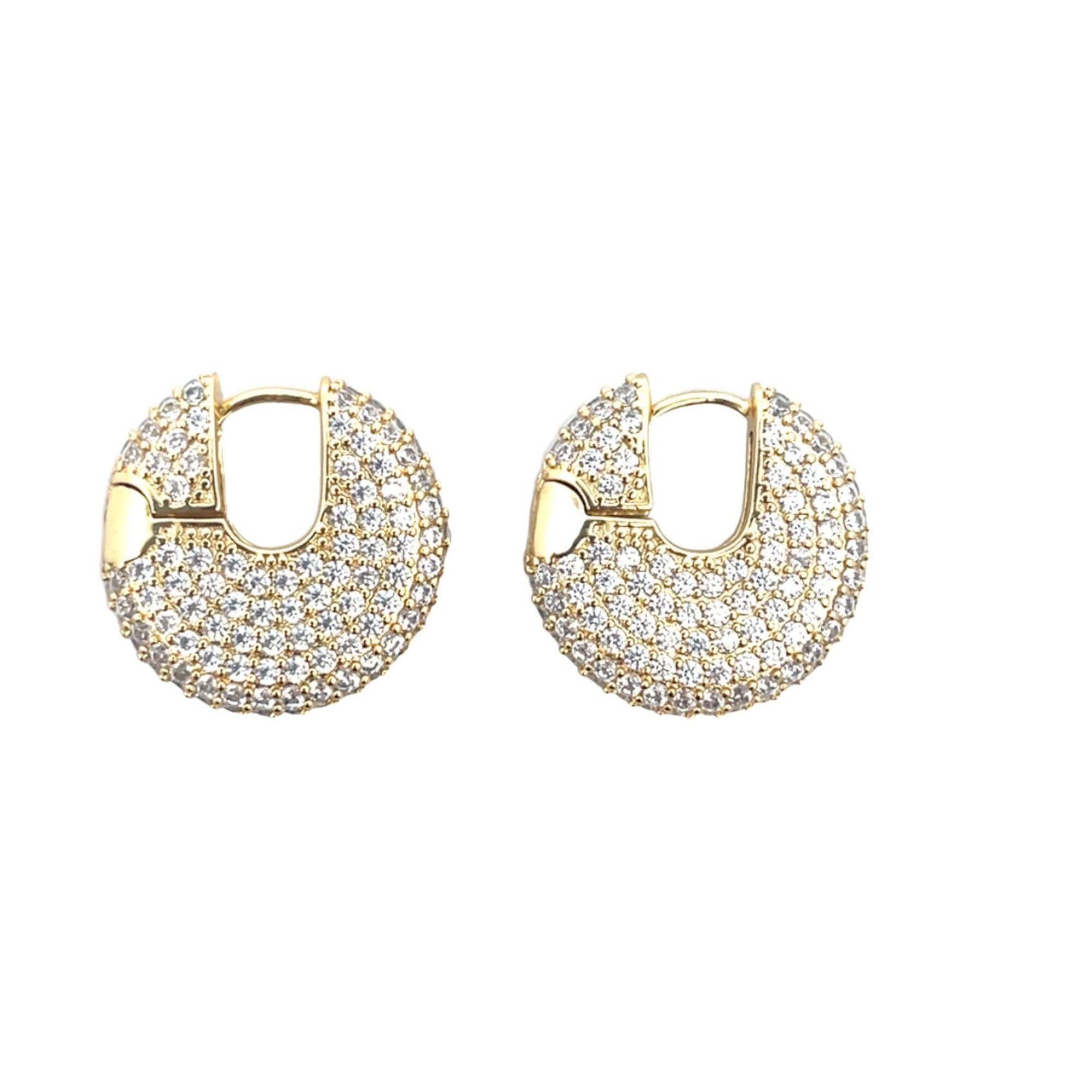 A pair of gold pave-set diamond huggie hoop earrings sparkles against a clean white background.