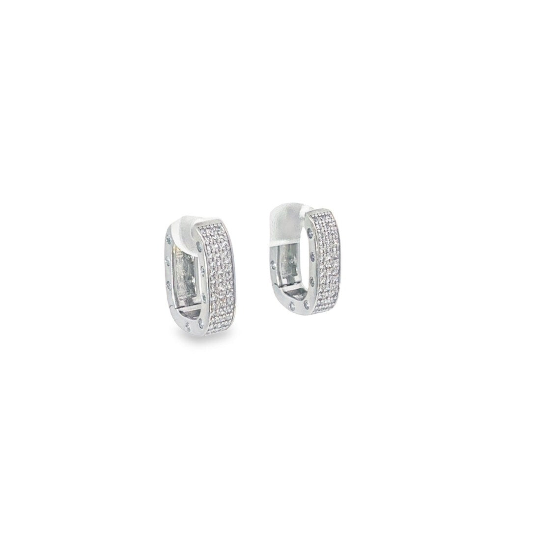 A pair of silver pave-set diamond huggie hoop earrings sparkles against a clean white background.