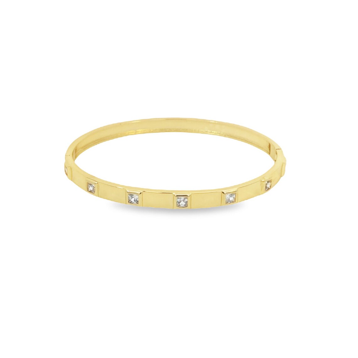 A sleek gold bangle bracelet features evenly spaced square-cut diamonds embedded along its band.