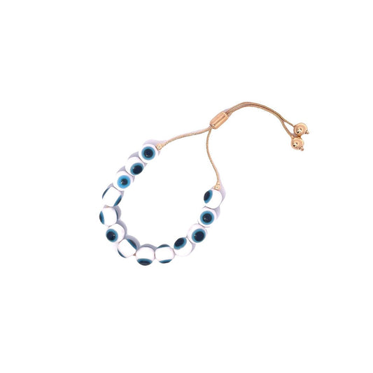 A gold adjustable evil eye bracelet features white and blue glass beads against a clean white background.
