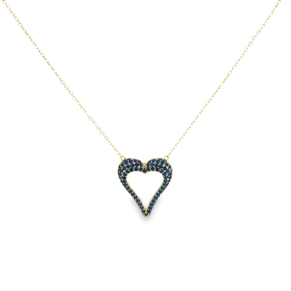 A delicate gold chain holds a sparkling blue sapphire-pave heart pendant against a white background.